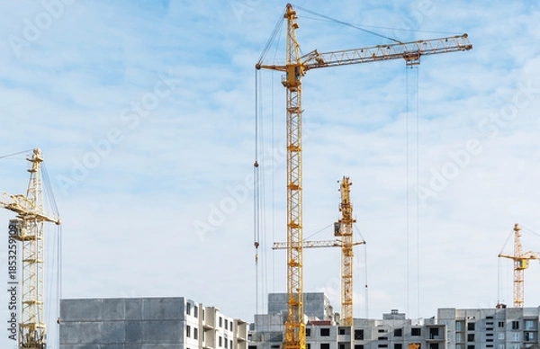 Obraz High-rise construction cranes work on construction sites