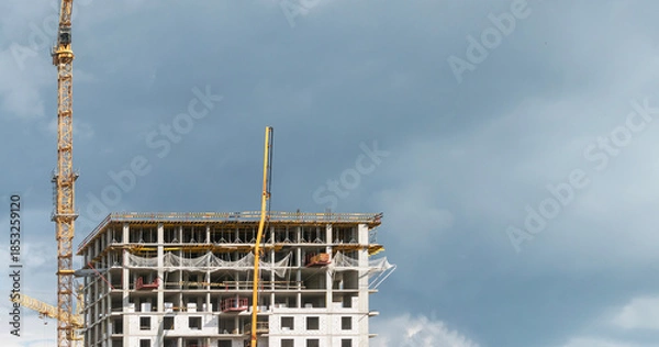 Obraz High-rise construction cranes work on construction sites