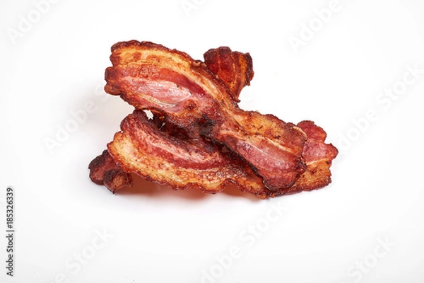 Obraz Three cooked, crispy fried bacon isolated on a white background.