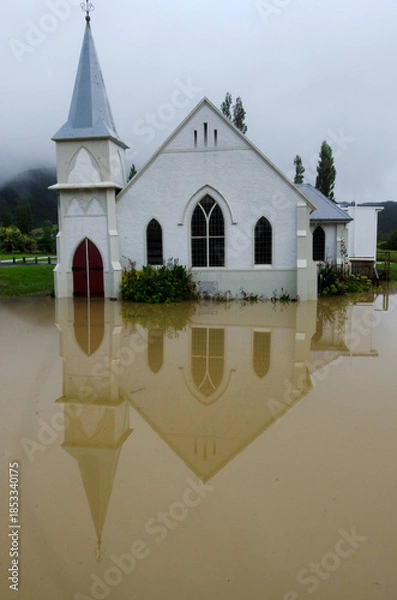 Fototapeta Flood waters surround the Memorial Church in Kaeo Northland New Zealand