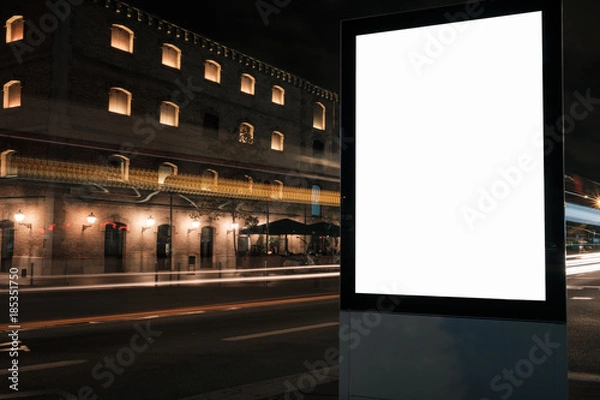 Fototapeta Blank white advertisement lightbox at night. Mock-up design. Car light lines.