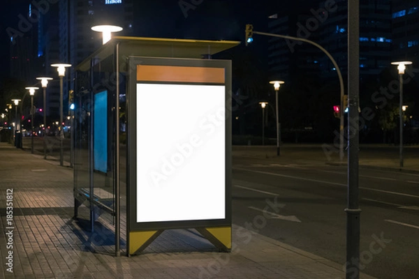 Fototapeta Blank space for advertisement at a bus stop. Lightbox mock-up at night. Horizontal.