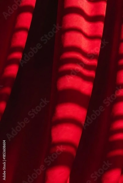Obraz A Dramatic Red Curtain With Striking Light And Shadow Patterns - Abstract Stage Background