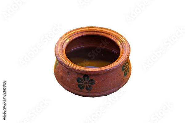 Fototapeta A rustic, round terracotta pot, brown earthenware, shows horizontal lines from its creation. Its a simple, traditional cooking or storage vessel.