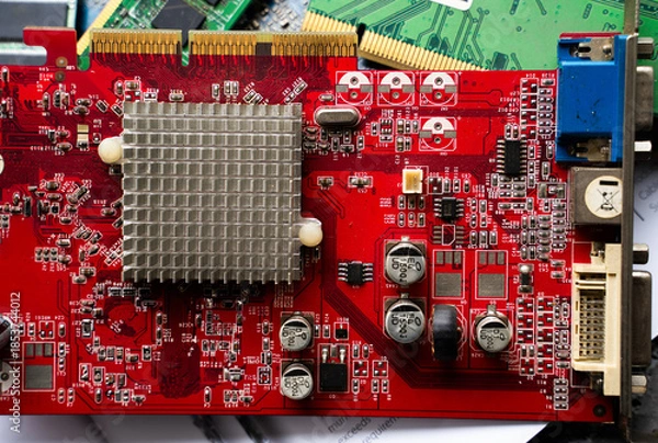 Obraz Red printed circuit board with heatsink and electronic components. Computer hardware and electronics technology background.