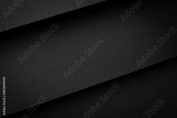 Obraz Black paper sheets layered on a flat surface create a simple design