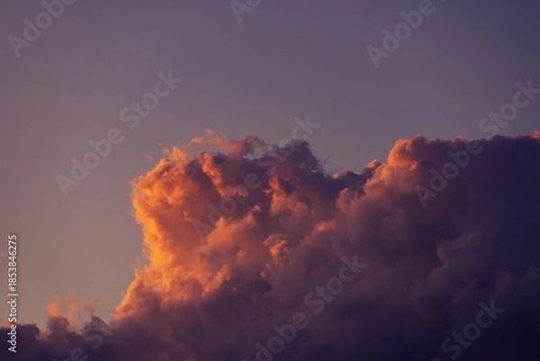 Obraz Dramatic sunset clouds against a twilight sky.