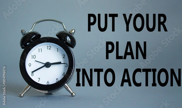 Obraz Put your plan into action symbol. Concept words Put your plan into action on white puzzle. Beautiful grey background with alarm clock. Business concept and Put your plan into action. Copy space.