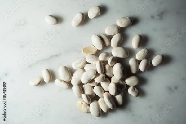 Obraz Isolated white beans on white marble