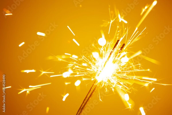 Obraz sparkler on a yellow background close-up. tinted
