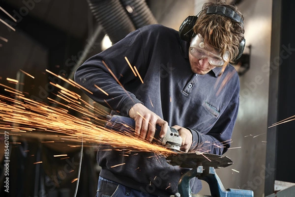 Obraz young farmer working with a grinder