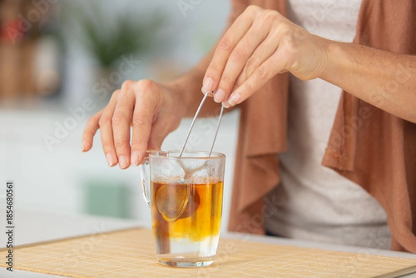 Obraz close view of tea infusing into water