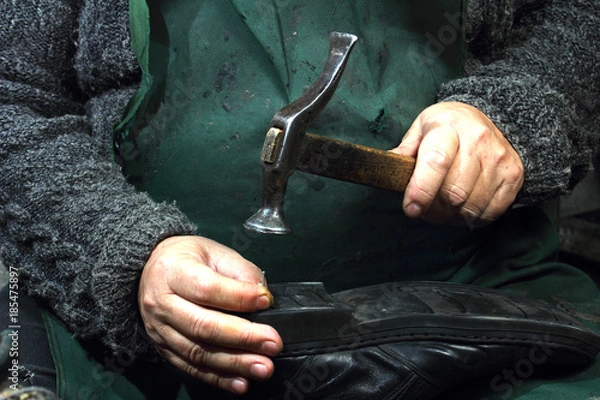 Fototapeta Shoemaker homeworkers.Small business in Russia - forced servitude?Running very old equipment.the hands of Salonika.