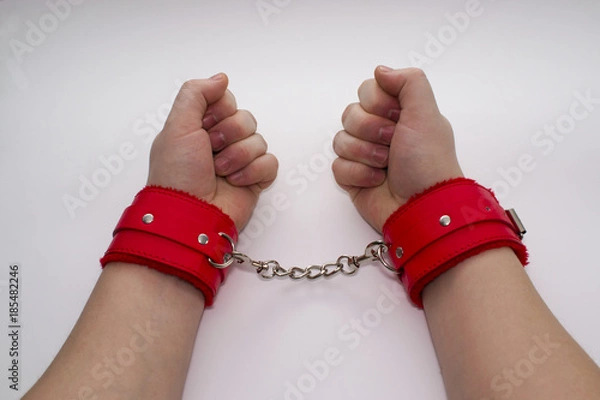 Obraz Female hands in leather handcuffs.