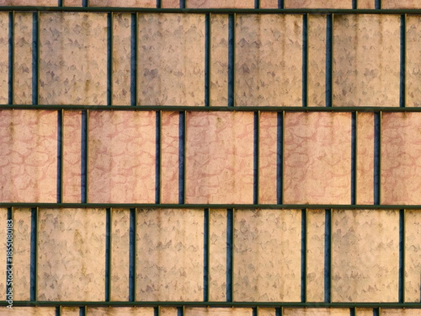 Obraz Barbed wire fence with old privacy strips, background