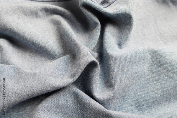 Obraz Dramatic lighting on denim fabric. Background, wallpaper.