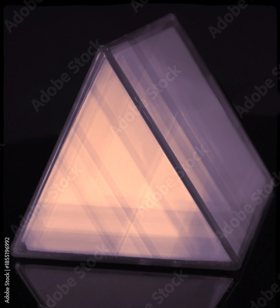Obraz A triangular prism shape abstract with glow effect on a black background