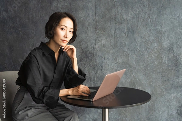 Obraz テーブルでラップトップを操作する女性　ライフスタイルイメージ