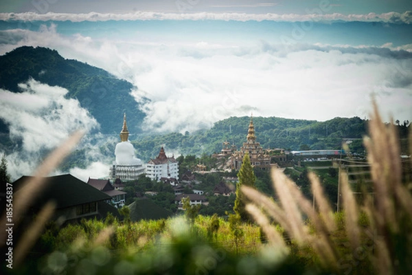 Fototapeta Big Buddha statue and pagoda on top of a hill with great views of the surrounding mountainous area at Wat Pha Sorn Kaew Temple in Khao Kho, Phetchabun Province, Thailand.