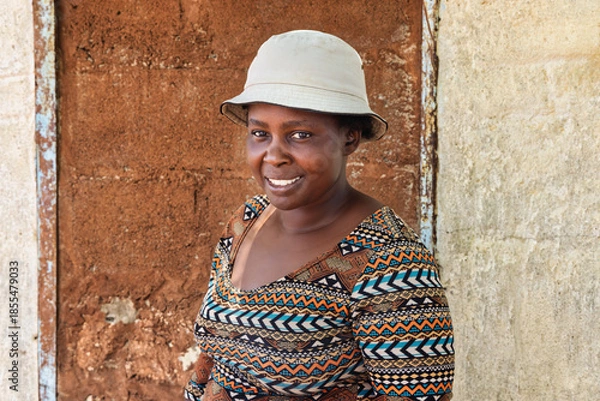 Obraz village happy african woman portrait, outdoors in the nature ,at home wall behind