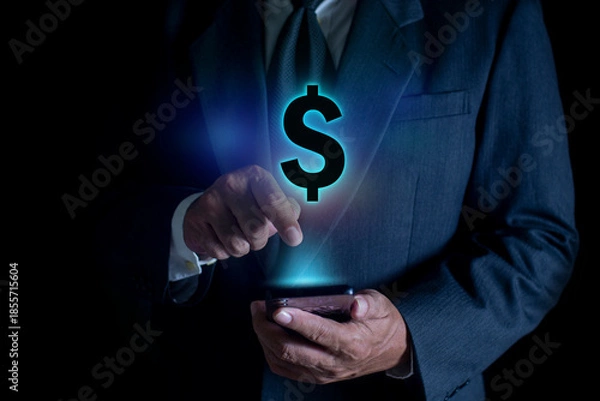 Obraz Man holding smartphone with floating dollar signs. Concept of online banking, mobile payments, finance management, and digital money transactions.