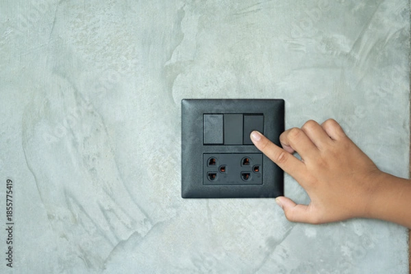 Obraz hand holding a light switch