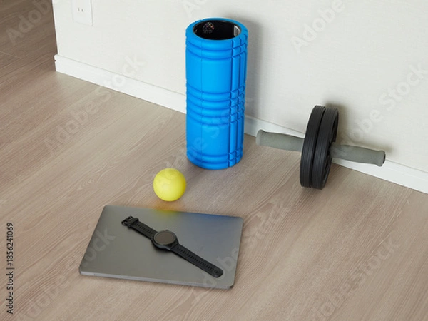 Obraz 家のリビングの床にあるノートパソコンと運動用のローラーなどのエクササイズ用品