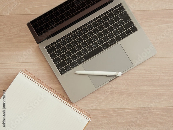 Obraz 机の上にあるノートブックとボールペンとノートパソコンの様子