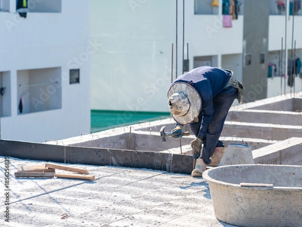 Obraz Construction workers assembling wooden formwork