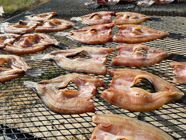 Obraz cooking fish in the open air on the grill in the village