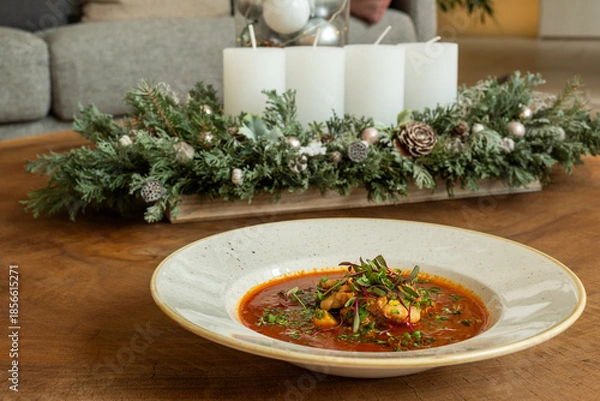Obraz Gourmet fish soup with herbs served on rustic holiday table
