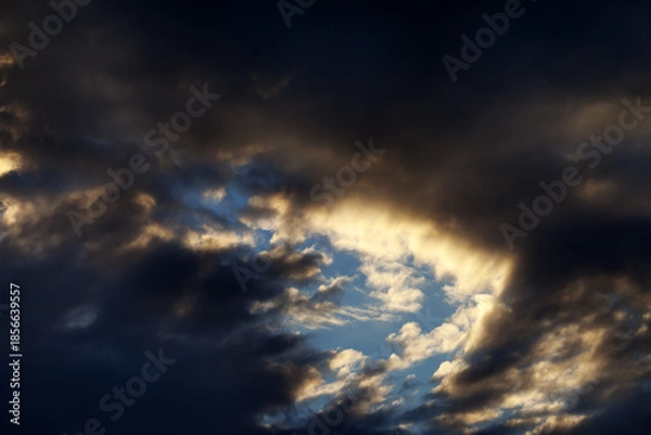 Fototapeta Storm clouds on sunset sky