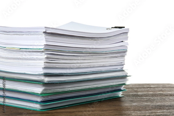 Fototapeta Stack of documents on table against white background