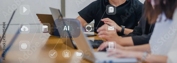 Fototapeta オフィスの会議テーブルでノートパソコンを使うビジネスチーム、AIとデータ連携のイメージ、IT企業の業務シーン