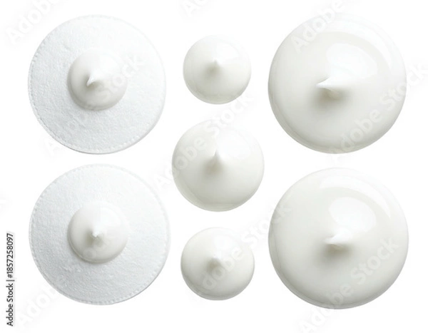 Fototapeta Overhead shot of white creamy mounds with varying textures on black