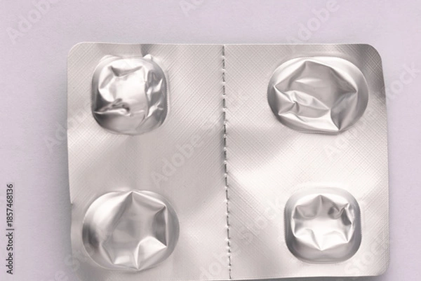 Obraz Silver blister pack from tablets with empty compartments, crumpled