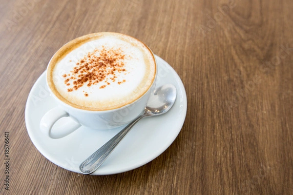 Obraz hot cappuccino on wooden table 