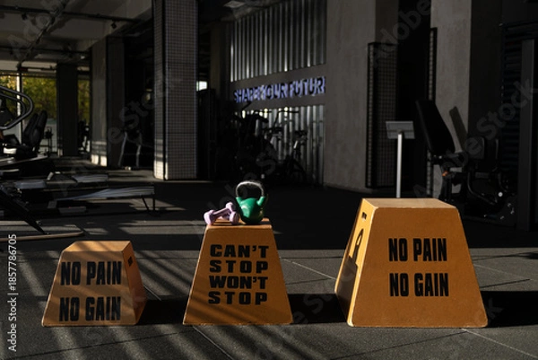 Obraz Three Motivational Step Boxes with Weights on Center Box