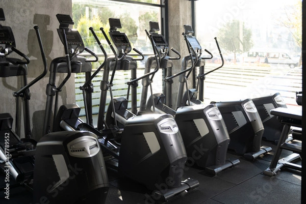Obraz Five Elliptical Machines Side by Side in Gym