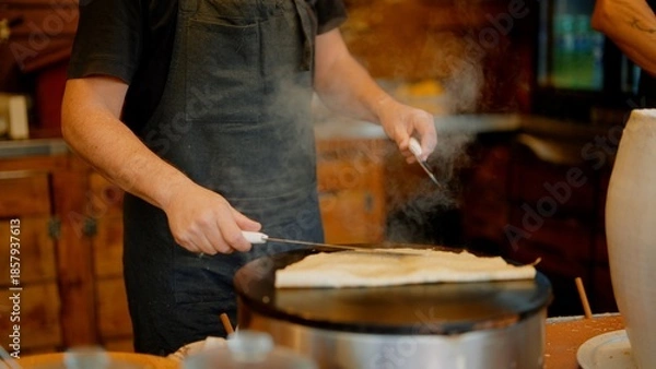 Obraz Using steady hands and spreader to shape batter into even circle