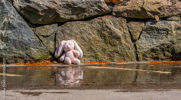Obraz Abandoned teddy bear by stone wall after rain.