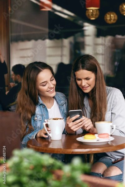 Obraz Happy Women Using Phone In Cafe.