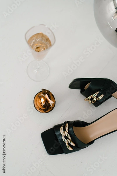 Obraz Elegant Black Sandals With Candle And Champagne