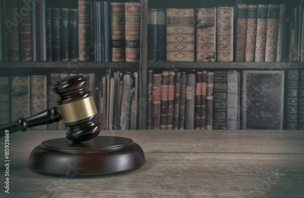 Fototapeta  law theme, mallet of the judge, wooden desk, old books