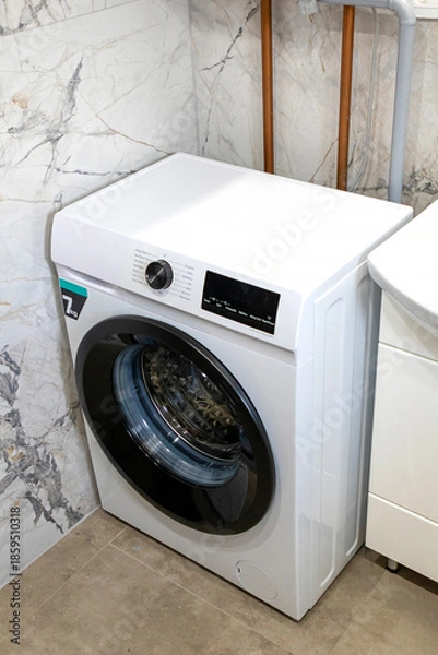 Obraz Modern laundry washing machine inside small bathroom interior