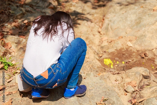 Fototapeta Woman hiking around mountains near the river at spring time.