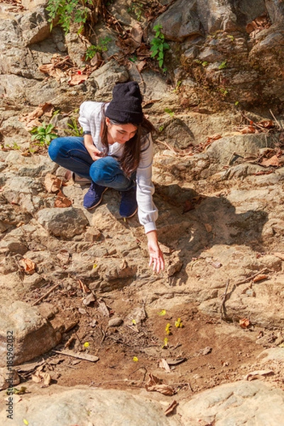 Fototapeta Woman hiking around mountains near the river at spring time.
