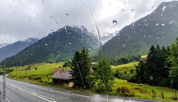 Obraz Mountain landscape view through rain-streaked window