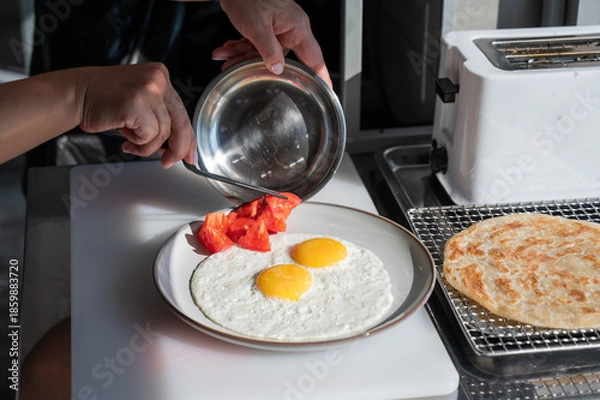 Obraz Chef serves fried eggs in a cafe. 