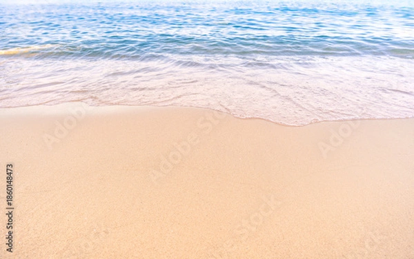 Obraz Soft blue ocean waves gently lapping onto a pristine tropical sandy beach